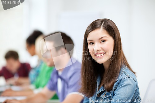 Image of student with computer studying at school