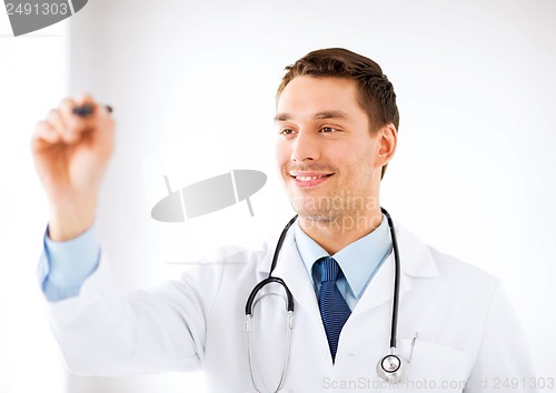 Image of young doctor working with something imaginary