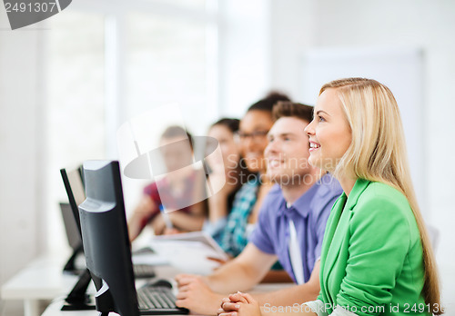 Image of students with computers studying at school