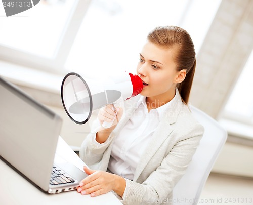 Image of strict businesswoman shouting in megaphone