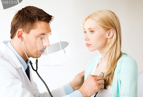 Image of doctor with stethoscope listening to the patient