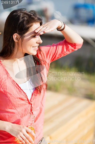 Image of girl with drink on the beach