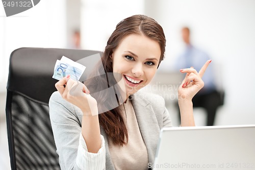 Image of pensive businesswoman with cash money