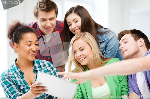 Image of students looking at tablet pc at school