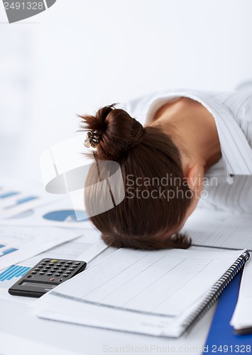 Image of woman sleeping at work in funny pose