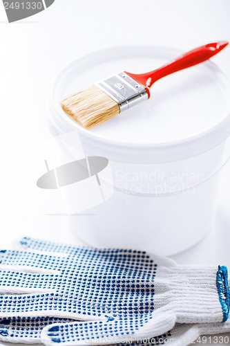 Image of paintbrush, paint pot and gloves