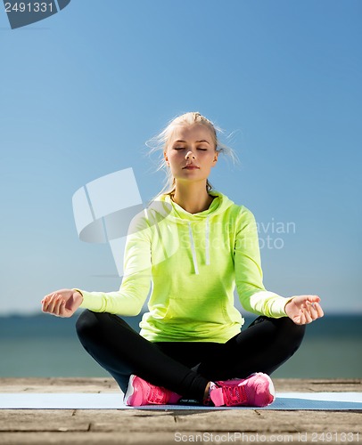 Image of woman doing yoga outdoors