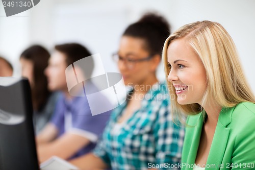 Image of students with computers studying at school