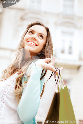 Image of woman with shopping bags in ctiy