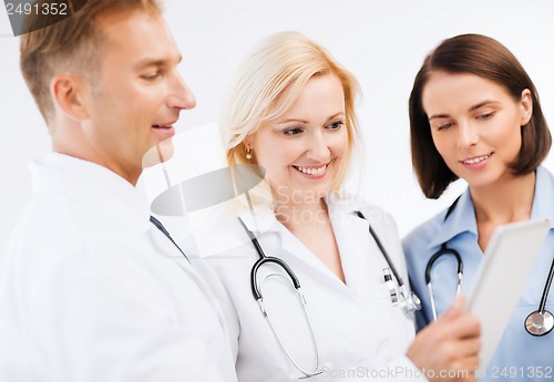 Image of doctors looking at tablet pc