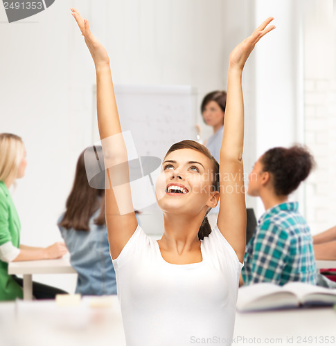 Image of happy student girl with hands up