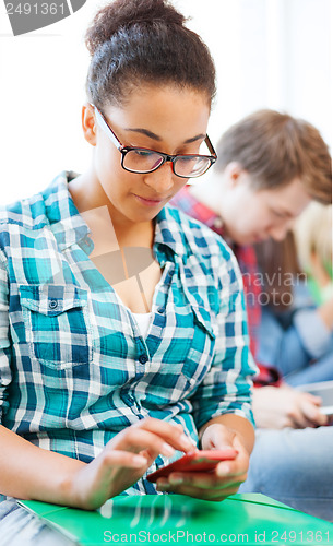 Image of student girl with smartphone at school
