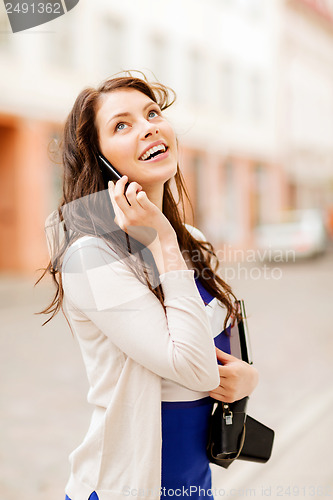 Image of girl with phone, tourist book and vintage camera