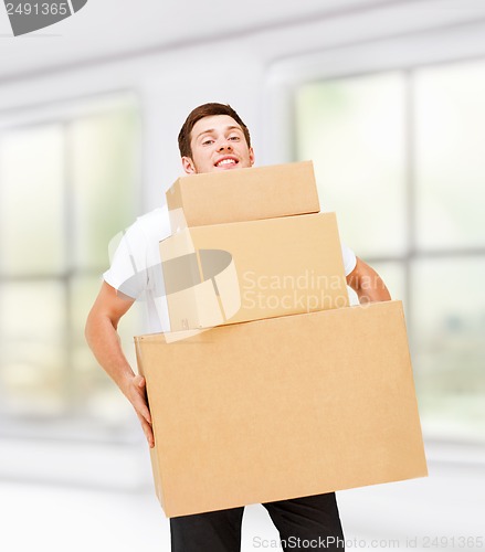 Image of young man carrying carton boxes