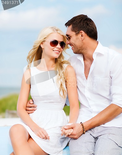 Image of couple in shades at seaside