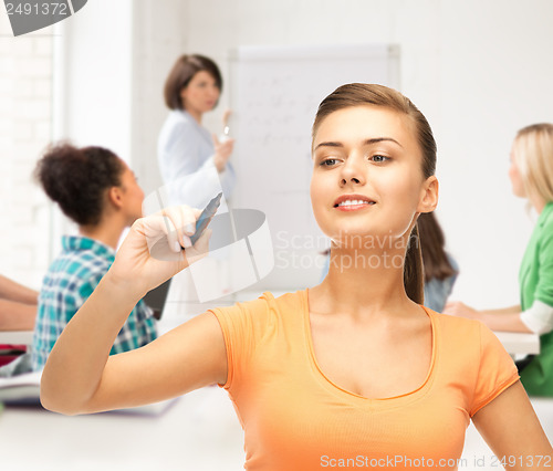 Image of student writing something in the air with marker