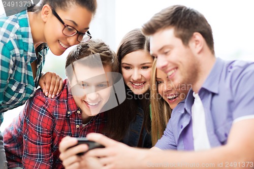 Image of students looking at smartphone at school