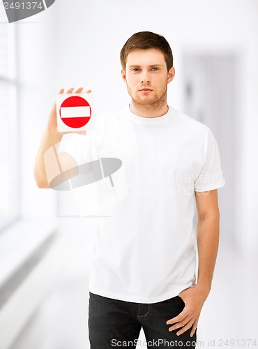 Image of young man showing no entry sign