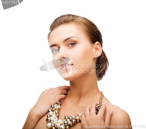 Image of woman wearing pearl statement necklace