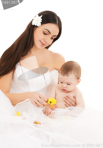 Image of bride in white dress with little baby