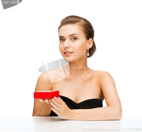 Image of woman with diamond earrings and gift box