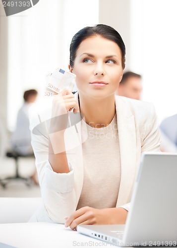 Image of pensive businesswoman with cash money