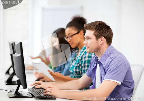 Image of students with computers studying at school