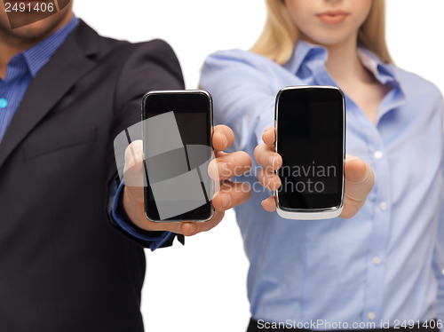 Image of woman and man hands with smartphones