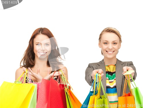 Image of attractive girls holding color shopping bags