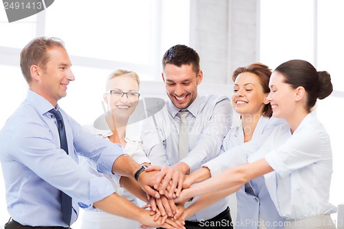 Image of business team celebrating victory in office