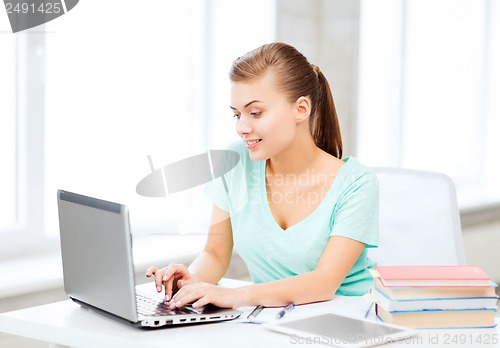 Image of smiling student girl with laptop