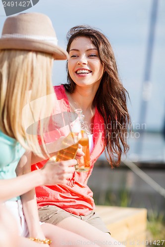 Image of girls with drinks on the beach