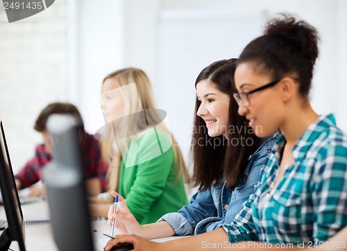 Image of students with computers studying at school
