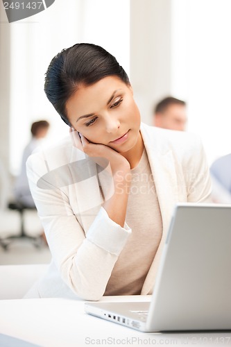 Image of businesswoman with laptop computer at work