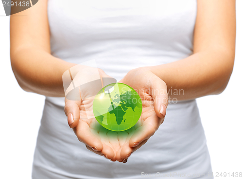 Image of woman hands holding green sphere globe
