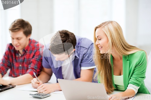 Image of students writing test or exam in lecture at school