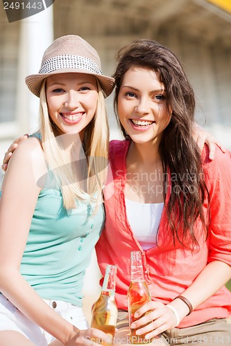 Image of girls with drinks on the beach