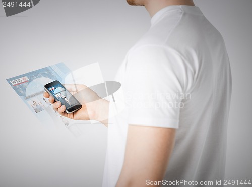 Image of man with smartphone reading news