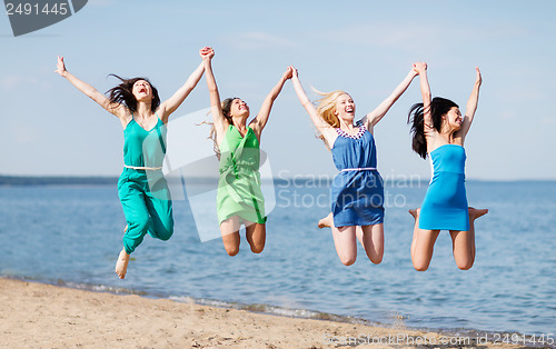 Image of girls jumping on the beach