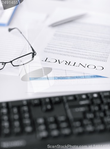 Image of signed contract paper with glasses