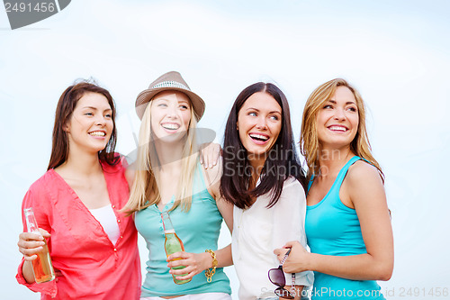 Image of girls with drinks on the beach