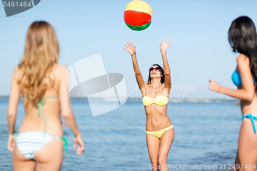 Image of girls with ball on the beach