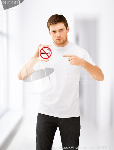 Image of young man pointing at no smoking sign