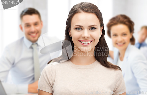 Image of attractive young businesswoman in office