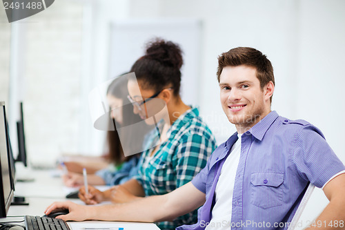 Image of student with computer studying at school