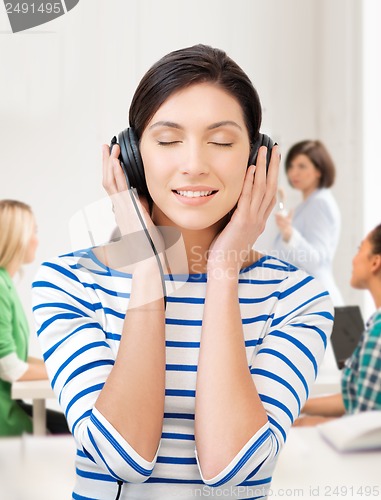 Image of student girl in big headphones at school