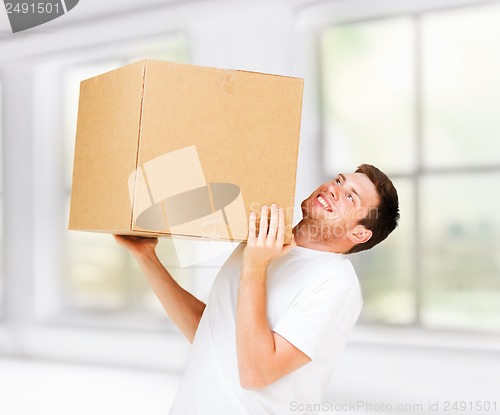 Image of man carrying carton heavy box