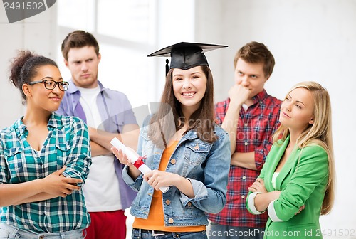 Image of girl in graduation cap with certificate