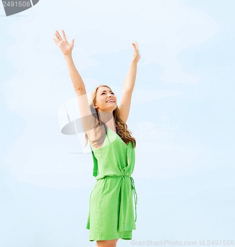 Image of girl with hands up in harbour