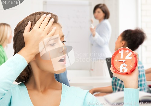 Image of attractive student looking at clock